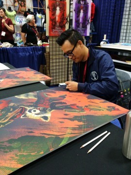 Kevin Tong signing his Rocket Raccoon print at San Diego Comic-Con